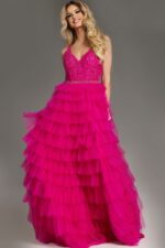Model wearing Jovani 37001 fuchsia dress with intricate bodice and high slit.