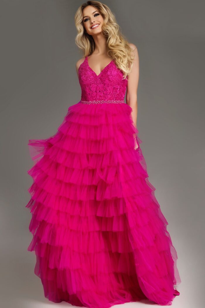 Model wearing Jovani 37001 fuchsia dress with intricate bodice and high slit.