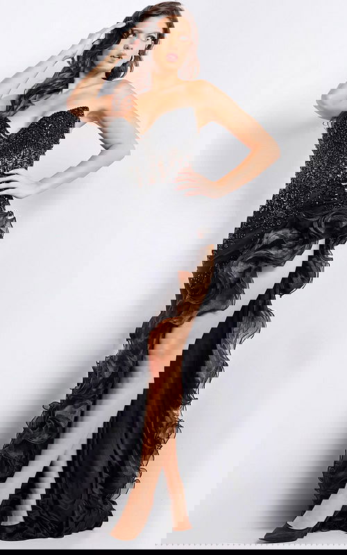 Model wearing Jovani 37036 black gown with ruffled high slit and embellished bodice from the front