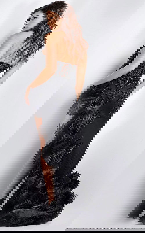 Model showing the back of Jovani 37036 black gown with embellished details