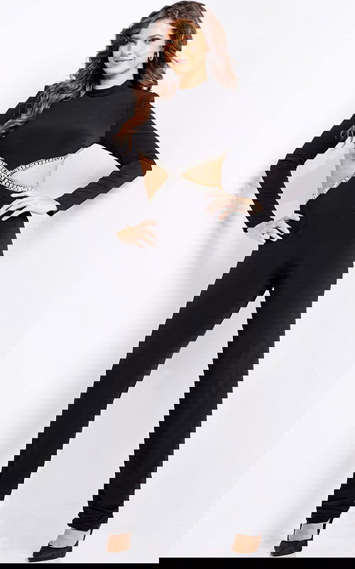 Model wearing Jovani 37038 black jumpsuit with long sleeves and cutout detailing.