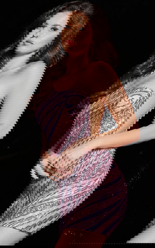 Model wearing Jovani 37974 pink sequin mini dress with one shoulder.