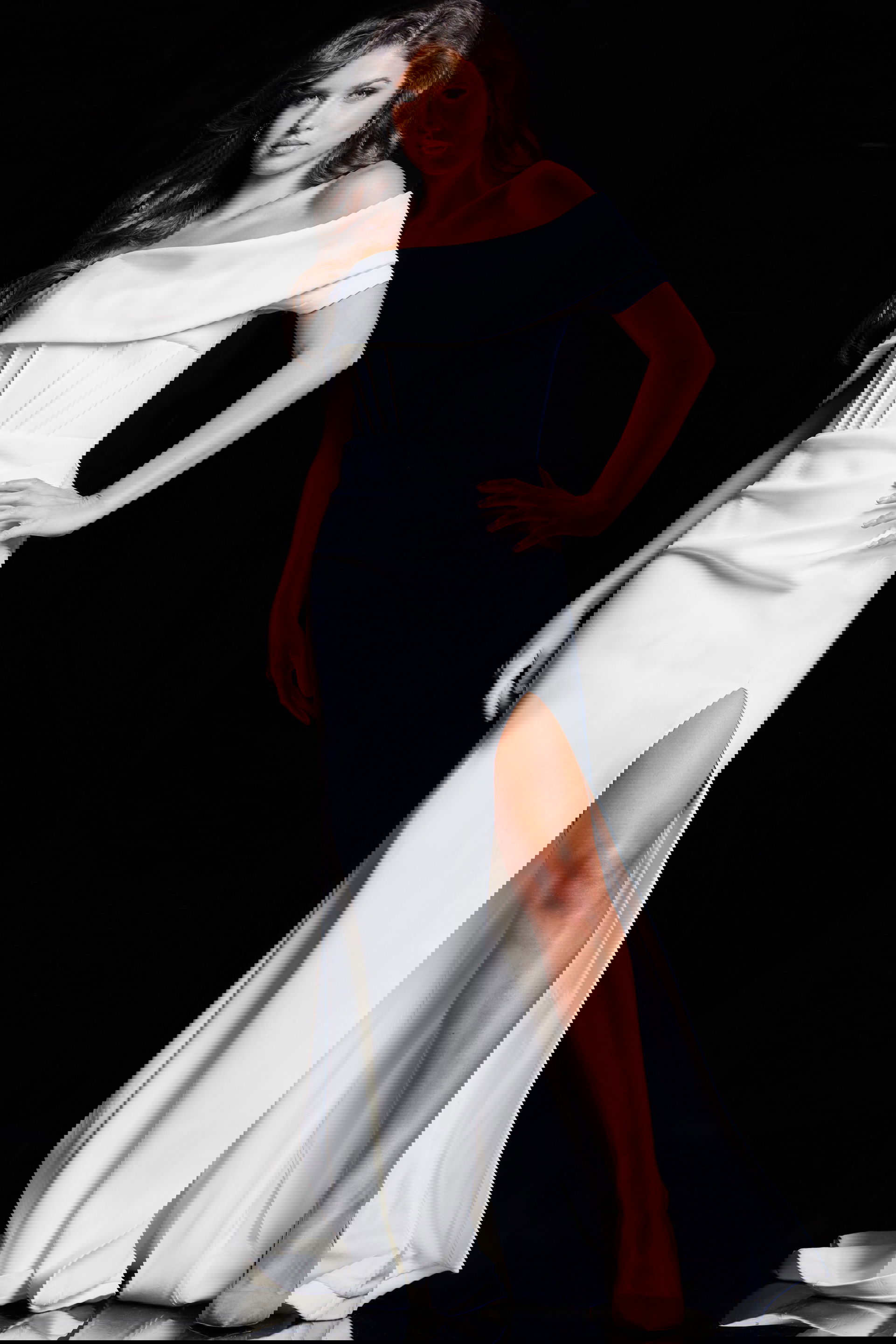 37148_WHITE_14.jpg Model wearing Jovani 37148 elegant white gown with off-the-shoulder neckline and high slit from the front.