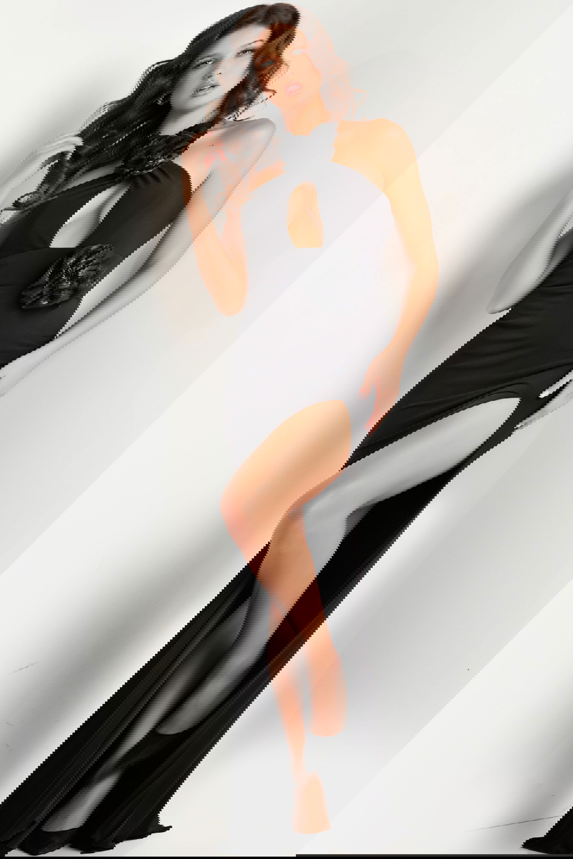 37164_black.jpg Model wearing Jovani 37164 black gown with floral accents, featuring a sleek silhouette and high slit.