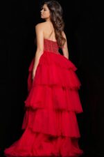 Model wearing Jovani 37210 red gown, back view showcasing tiered design.