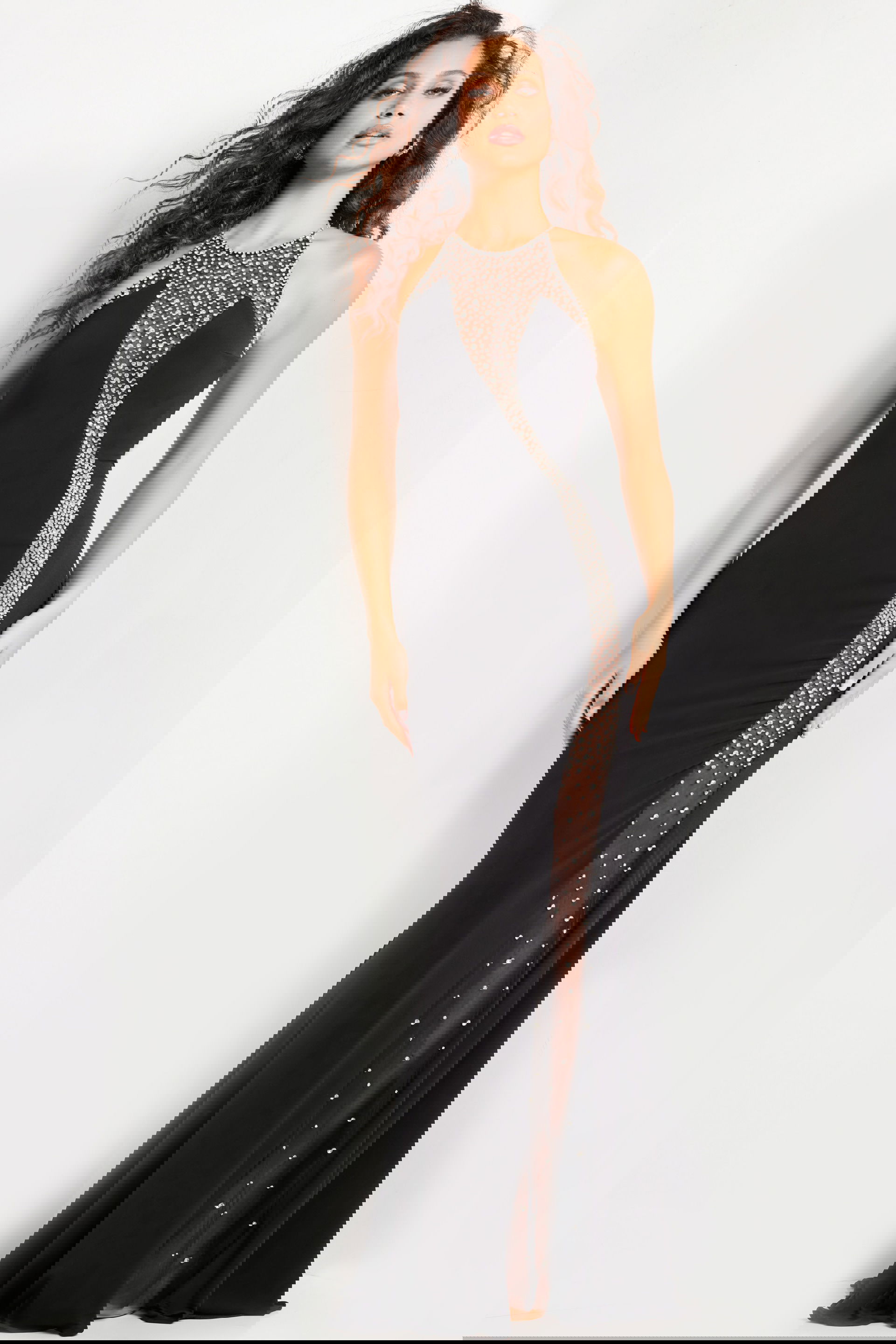 37215_BLACK_3-2.jpg model wearing Jovani 37215 black gown with halter neckline and beaded embellishments