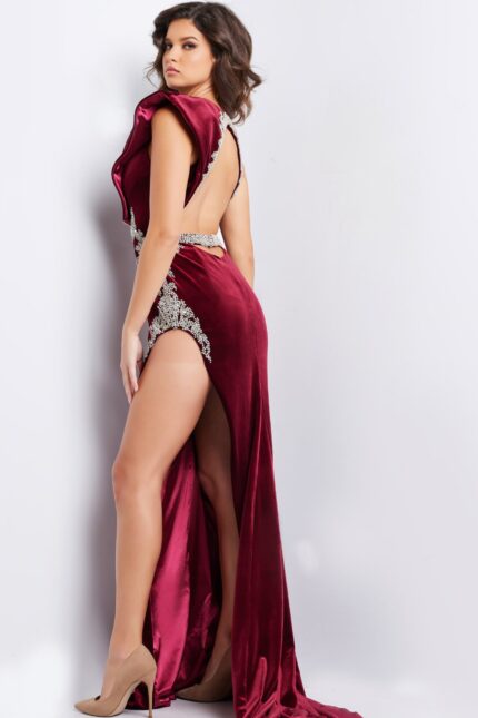 Back view of model in Jovani 37341 burgundy velvet dress with open back design