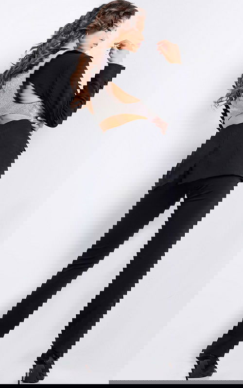 Model wearing Jovani 37347 showcasing the back with silver detail and tailored black pants.