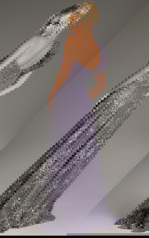 Model wearing Jovani 37353 navy gown, front view highlighting the floral embellishments and high slit.