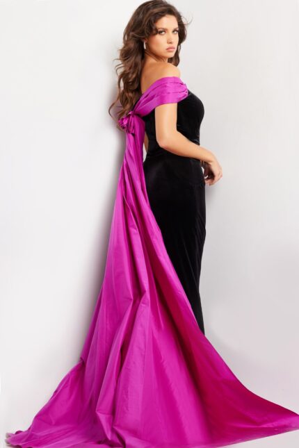 Back view of model wearing Jovani 37375, black gown with fuchsia cape.