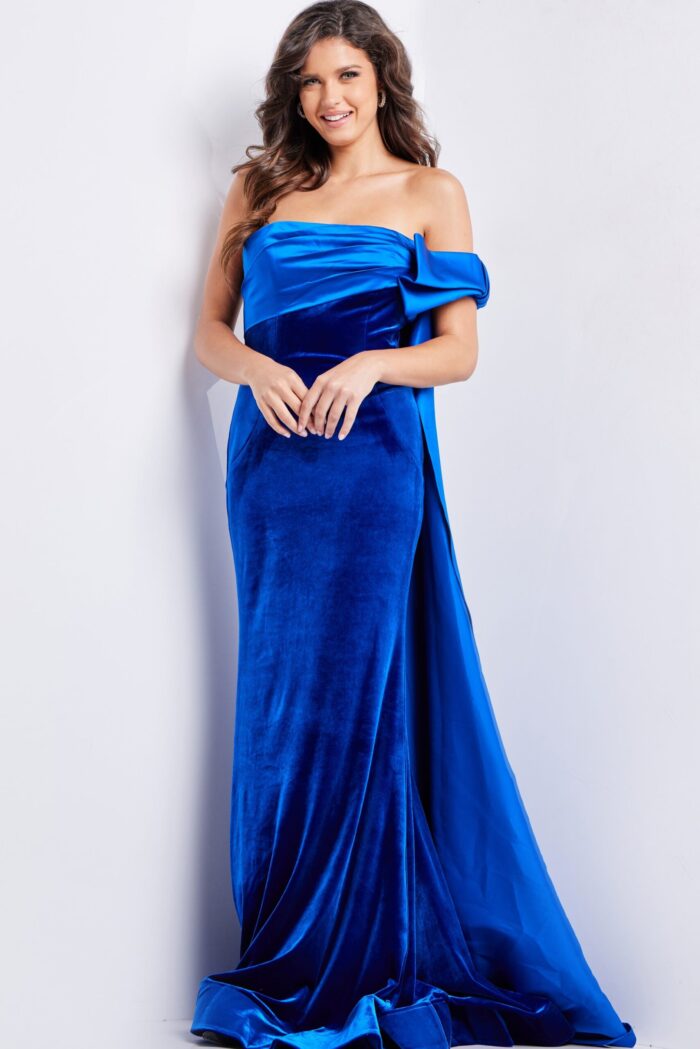 Model in Jovani 37390 royal blue dress showing front view with draped off-the-shoulder style.