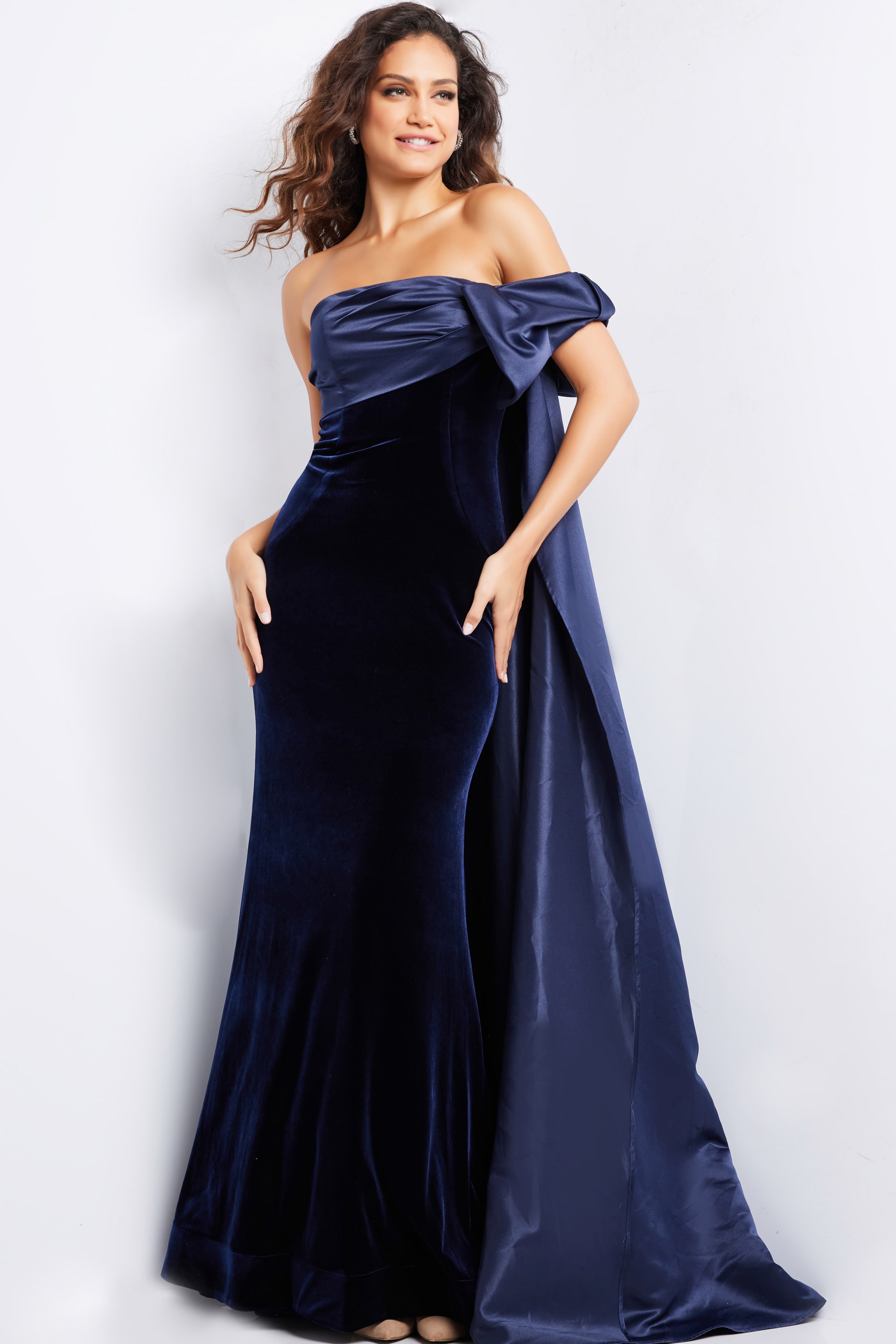 37391_NAVYNAVY_12.jpg Model wearing Jovani 37391 navy off-the-shoulder gown featuring an asymmetrical bow detail.