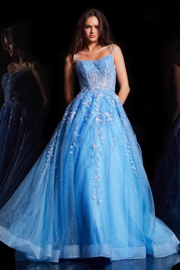 Model wearing Jovani 37421, a royal blue ball gown with scoop neckline and floral embroidery.