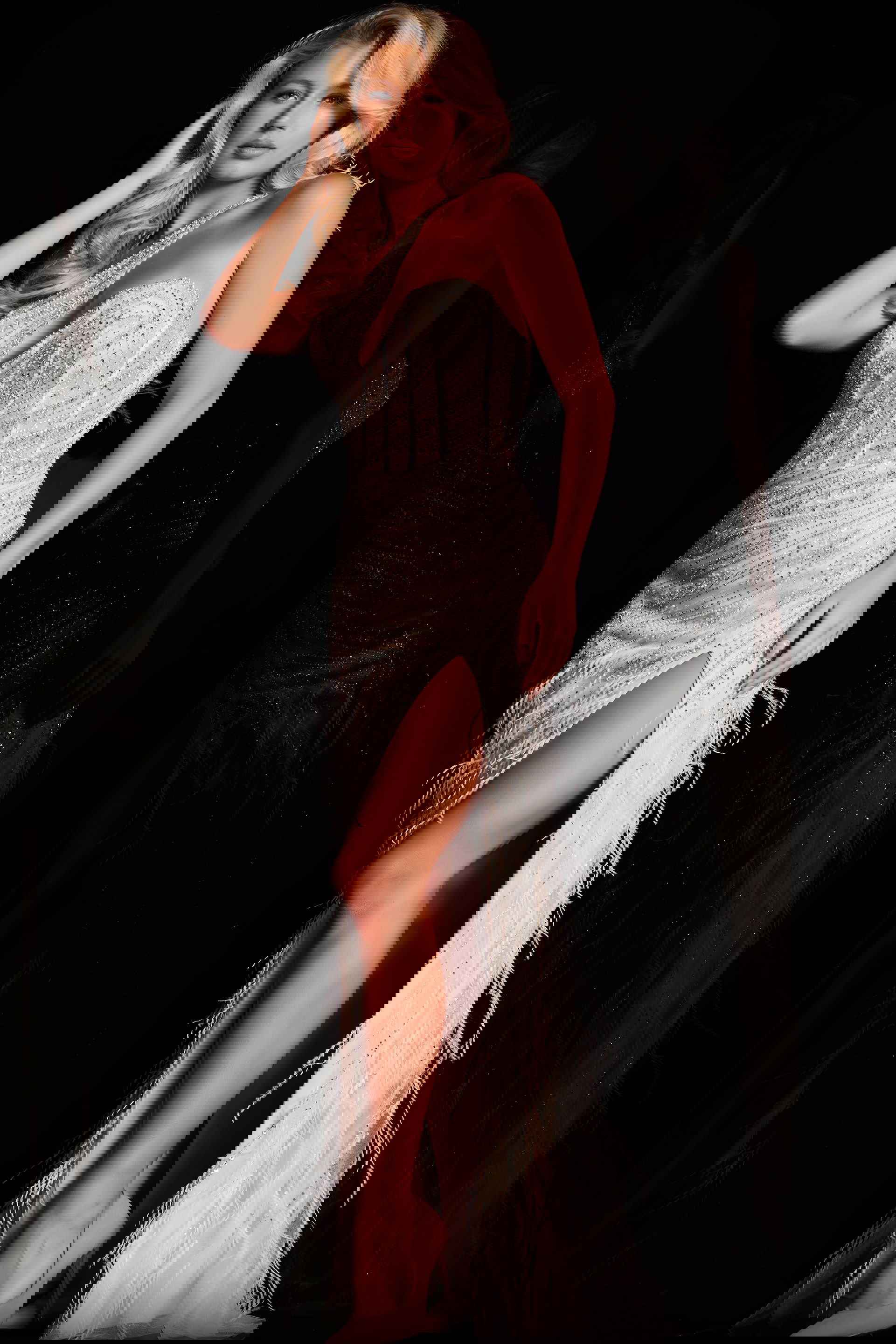 37442_3.jpg Model wearing Jovani 37442 white gown with feather details and high slit, front view.