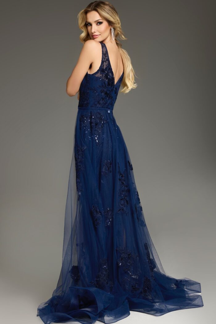 Model showcasing the back of Jovani 37600 navy gown featuring intricate lace details.