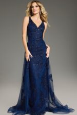 Model wearing Jovani 37600 navy gown with a fitted silhouette and V-neckline from the front.