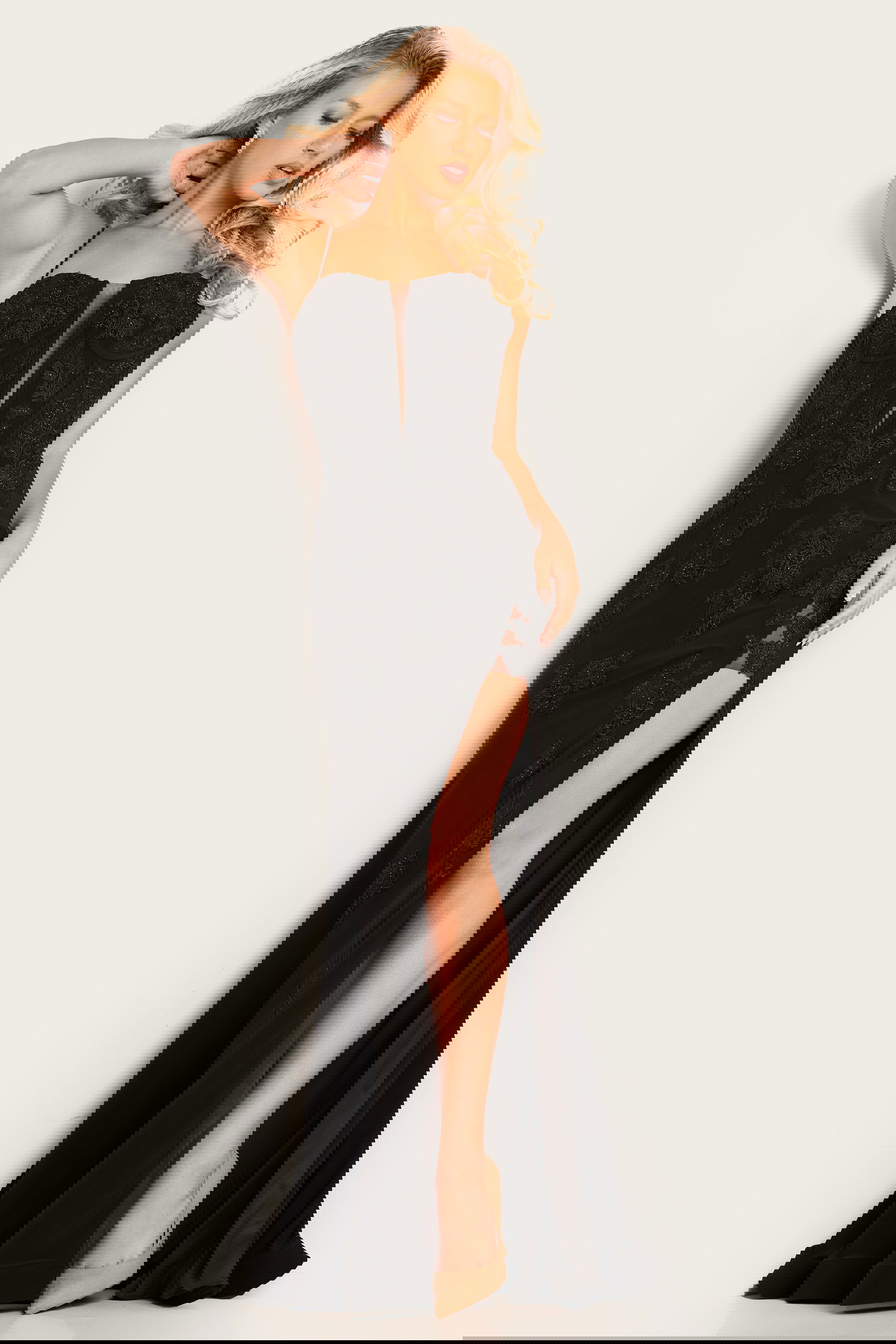 37624_black.jpg Model wearing Jovani 37624 black gown with deep V-neckline and floral embroidery.