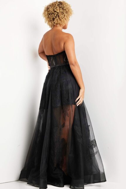 Back view of Jovani 37646 black dress showing flowy fabric and embroidery.