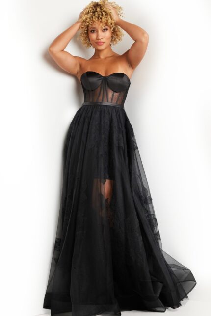 Model wearing Jovani 37646 black dress with illusion bodice and A-line silhouette.