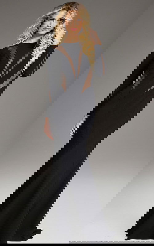 Model wearing Jovani 37671 black dress with high neckline and long sleeves featuring sheer mesh panels.