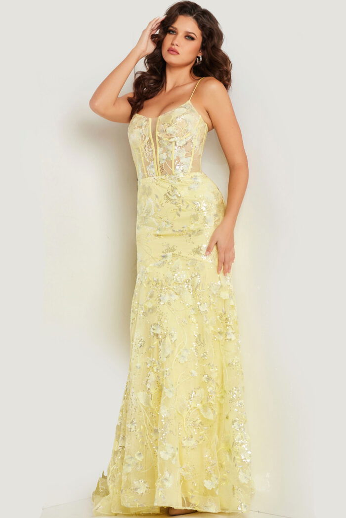 Model posing in Jovani 38004 yellow dress, showcasing intricate floral designs.