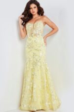 Model in Jovani 38004 yellow dress, highlighting exquisite floral embellishments.