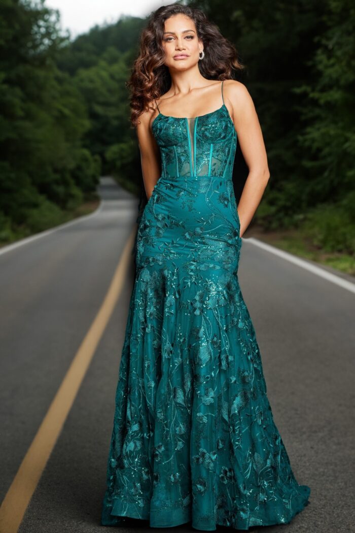Model wearing Jovani 38004 dark green dress with floral detailing, outdoor shot.