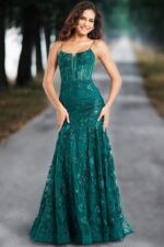 Model wearing Jovani 38004 dark green gown with elegant floral design, street view.