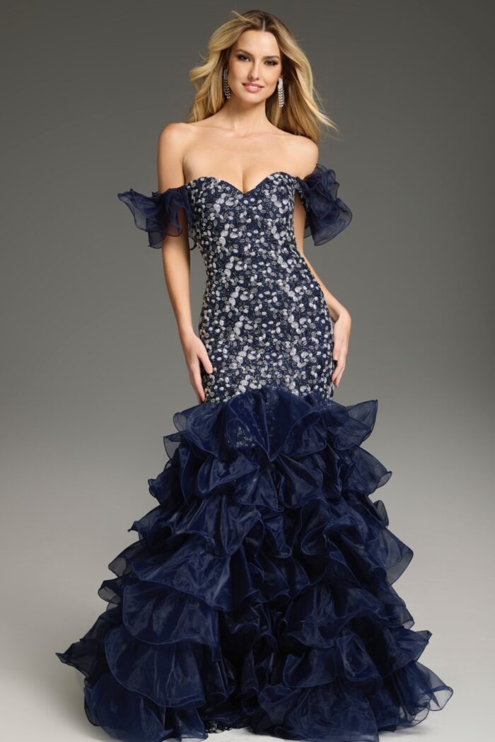 Model wearing Jovani 38115 navy mermaid dress with sweetheart neckline and off-shoulder ruffles, front view.