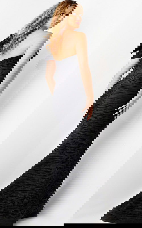 Back view of model wearing Jovani 38240 black dress with bow.