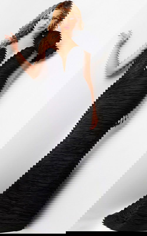 Model wearing Jovani 38240 black dress with deep V neckline and bow.