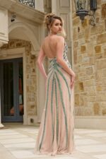 Model wearing Jovani 38263 dress with intricate back detailing, back view.