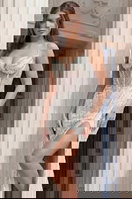 Close view of a corset style beaded gown with vertical detailing and slit