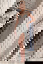 Beaded fitted gown with sheer corset bodice, thin straps, and front slit