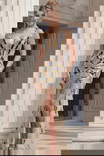 Sleeveless V neck gown with geometric beading, fitted silhouette, and front slit