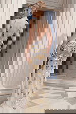 Back view of beaded sleeveless gown with deep V open back and floor length design