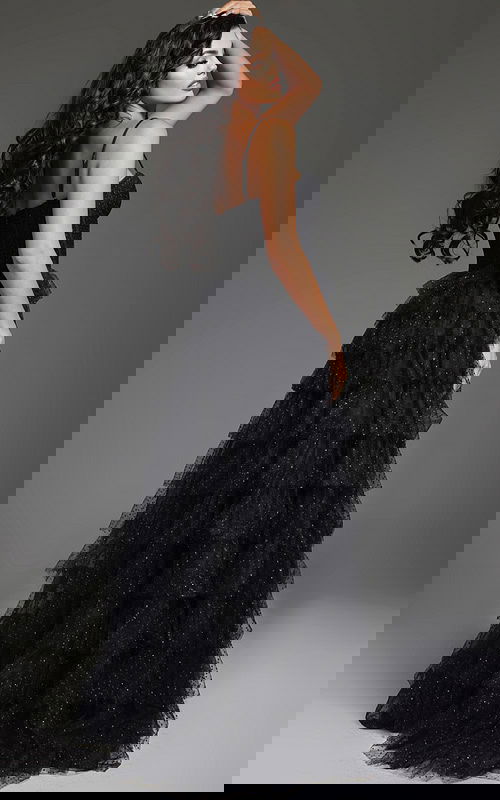 Back view of model wearing Jovani 38278 black evening gown showing tiered ruffle design.