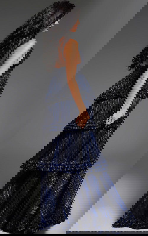 model wearing 38296 navy gown, back view showing layered ruffles