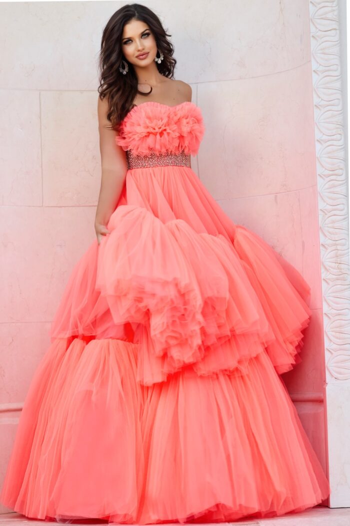 Model wearing Jovani 38299 orange gown with floral ruffles and embellished waist, back view.