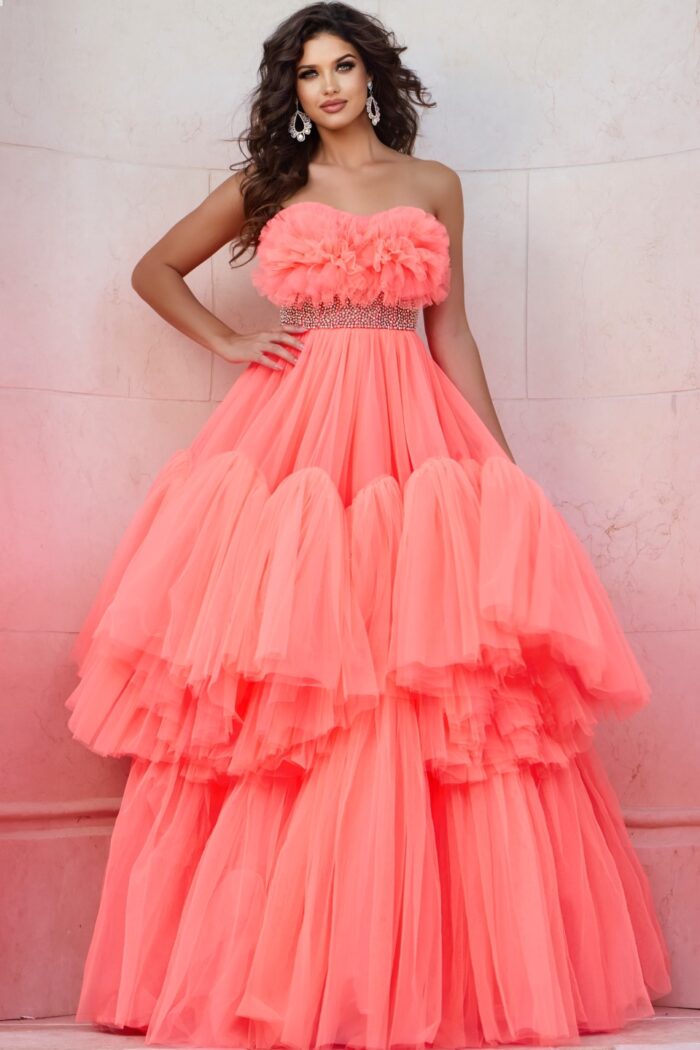 Model wearing Jovani 38299 orange gown with floral ruffles and embellished waist, front view.