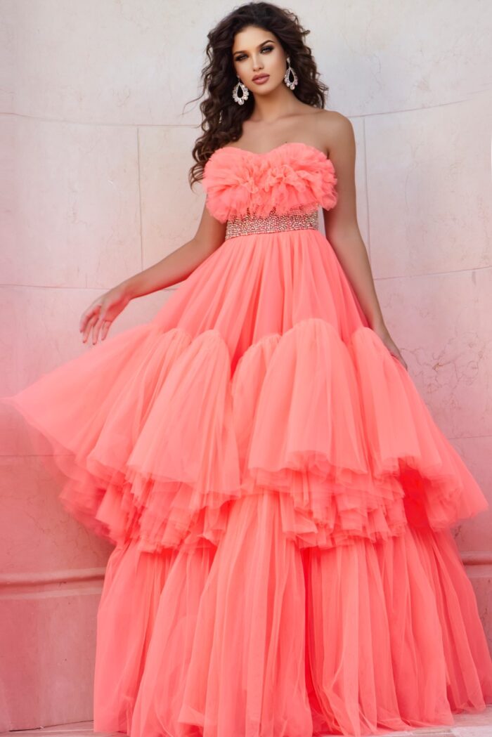 Model wearing Jovani 38299 orange gown with floral ruffles and embellished waist, front view.
