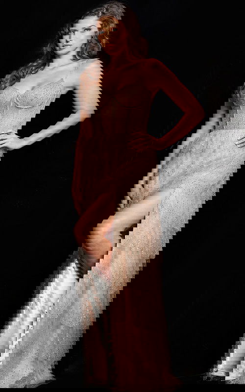 Model wearing Jovani 38431 beige gown with sweetheart neckline and high slit.