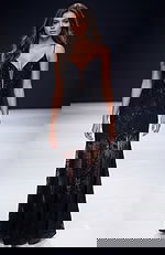 Fitted gown with sheer lace skirt, plunging illusion neckline, and delicate beaded detailing creating a sleek, elegant silhouette