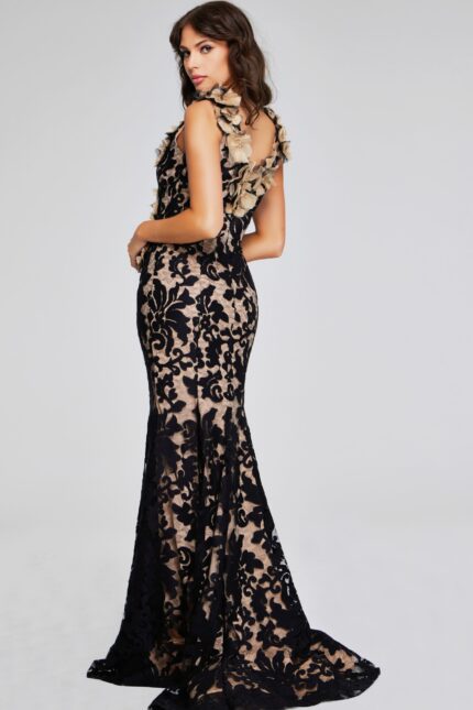 Model wearing Jovani 38497 black lace gown, back view showing open back design.