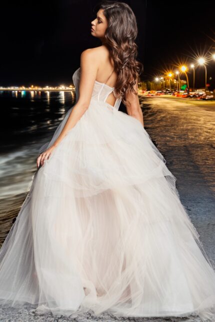 Back view of Jovani 38537 blush gown highlighting the flowing tulle skirt and open back.