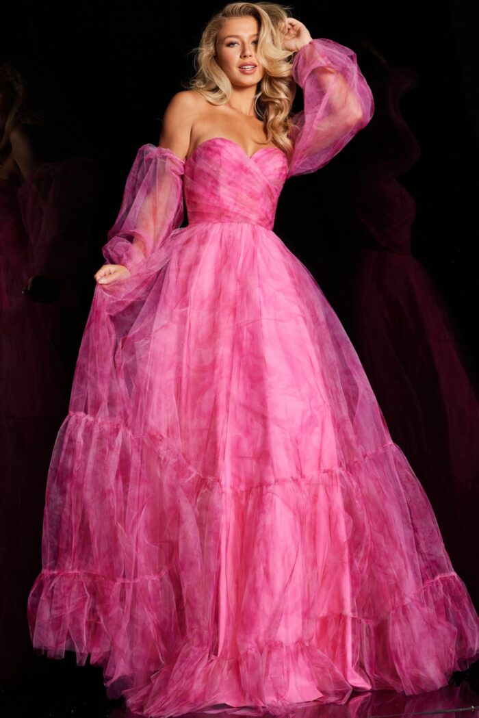 Model wearing Jovani 38605, a fuchsia off-the-shoulder gown with long billowing sleeves and A-line silhouette.