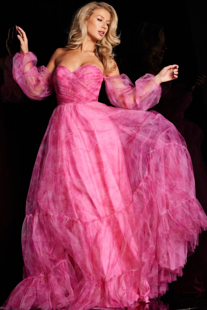 Model in Jovani 38605, showcasing a fuchsia gown with off-the-shoulder neckline and billowing sleeves.