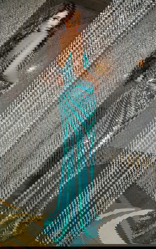 Back view of model wearing Jovani 38707 green gown with sequins.