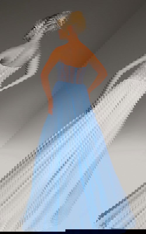 Model wearing Jovani 38946 black gown, back view showing elegant draping.