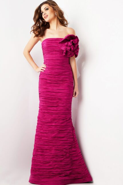 Model wearing Jovani 38947 fuchsia evening gown with strapless neckline and floral shoulder detail.
